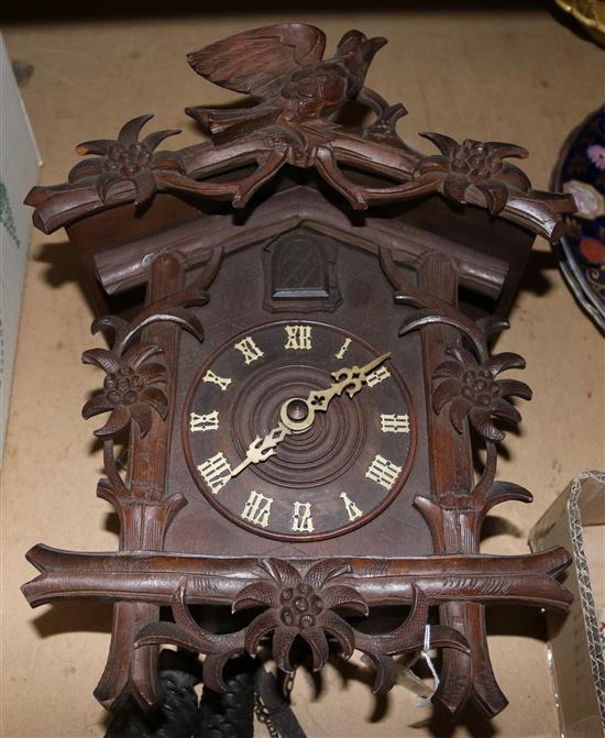 A Black Forest carved wood cuckoo clock, 12.5in.